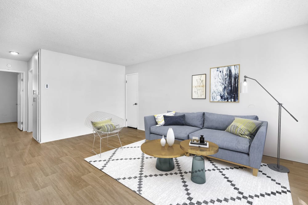 Living room with plank flooring at Vista Apartments in Chula Vista, California