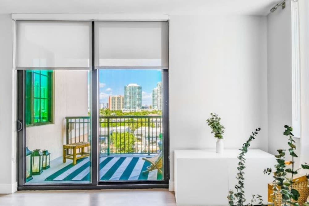 The sliding door to a balcony in a model apartment at Marina Del Sol in Sunny Isles Beach, Florida