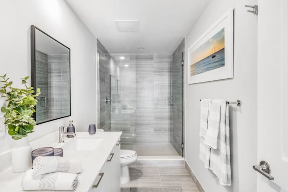 Wood flooring and white cabinets in an apartment bathroom at Marina Del Sol in Sunny Isles Beach, Florida