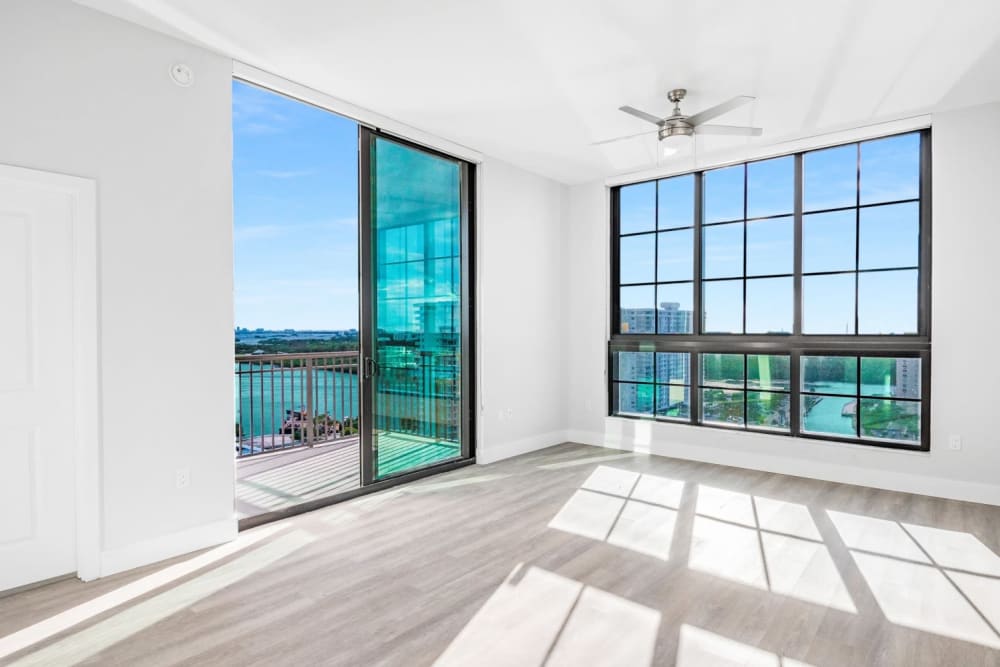 Wood flooring and tinted windows in an apartment living room at Marina Del Sol in Sunny Isles Beach, Florida