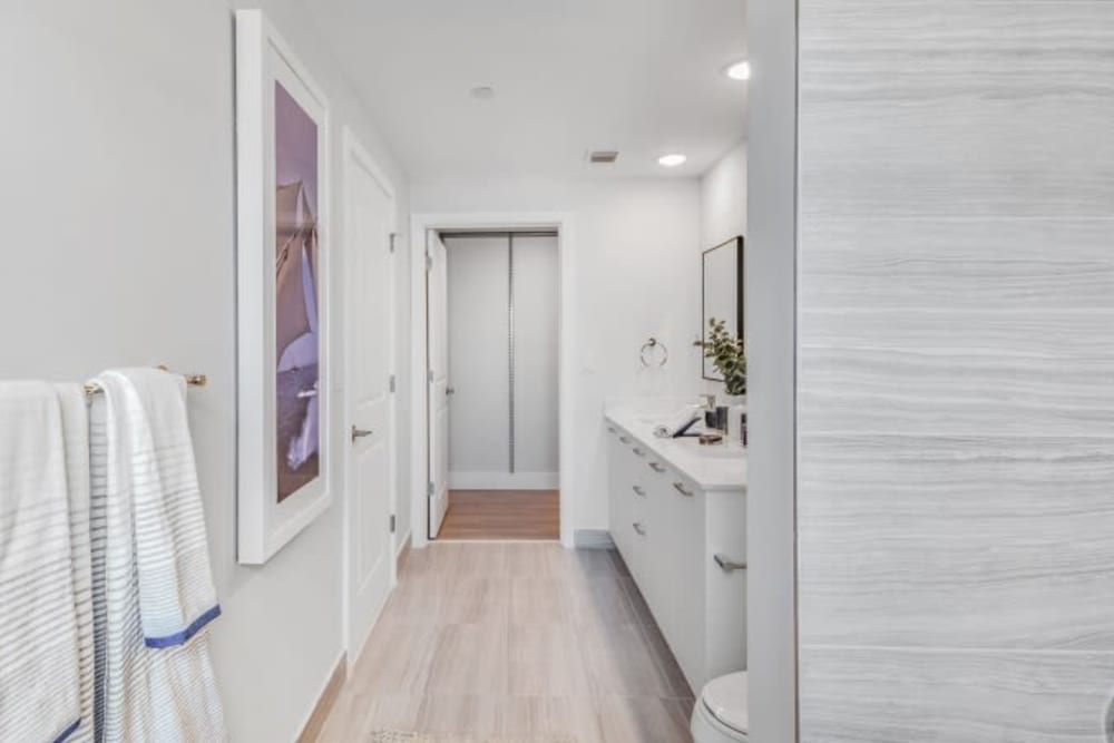 Wood flooring and white cabinets in an apartment bathroom at Marina Del Viento in Sunny Isles Beach, Florida