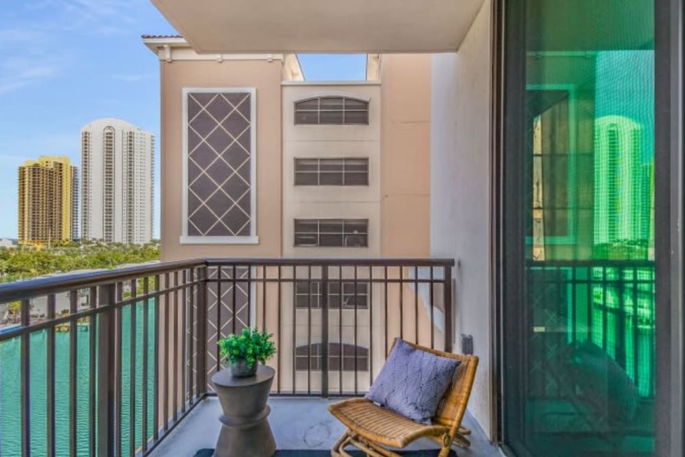 An outdoor chair on an apartment balcony at Marina Del Viento in Sunny Isles Beach, Florida