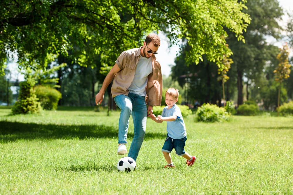 Resident father and son playing soccer near Parks at Nexton in Summerville, South Carolina