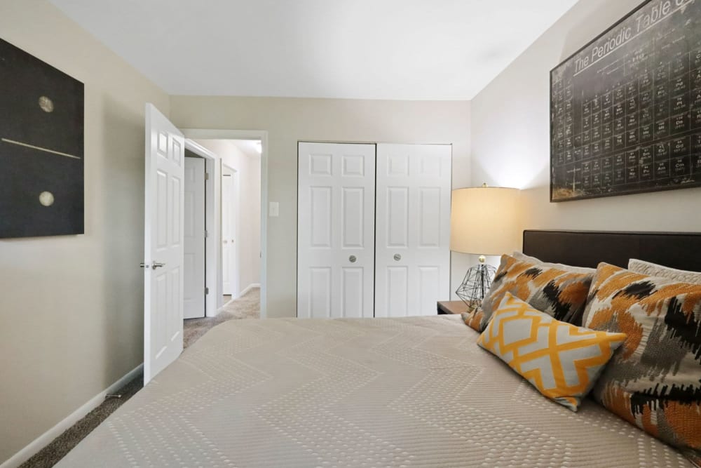 Bedroom with comfortable bed at The Seasons Apartments in Laurel, Maryland