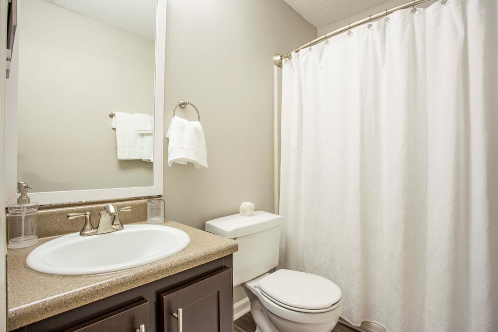 Bathroom with shower curtain at The Willows Apartments in Spartanburg, South Carolina
