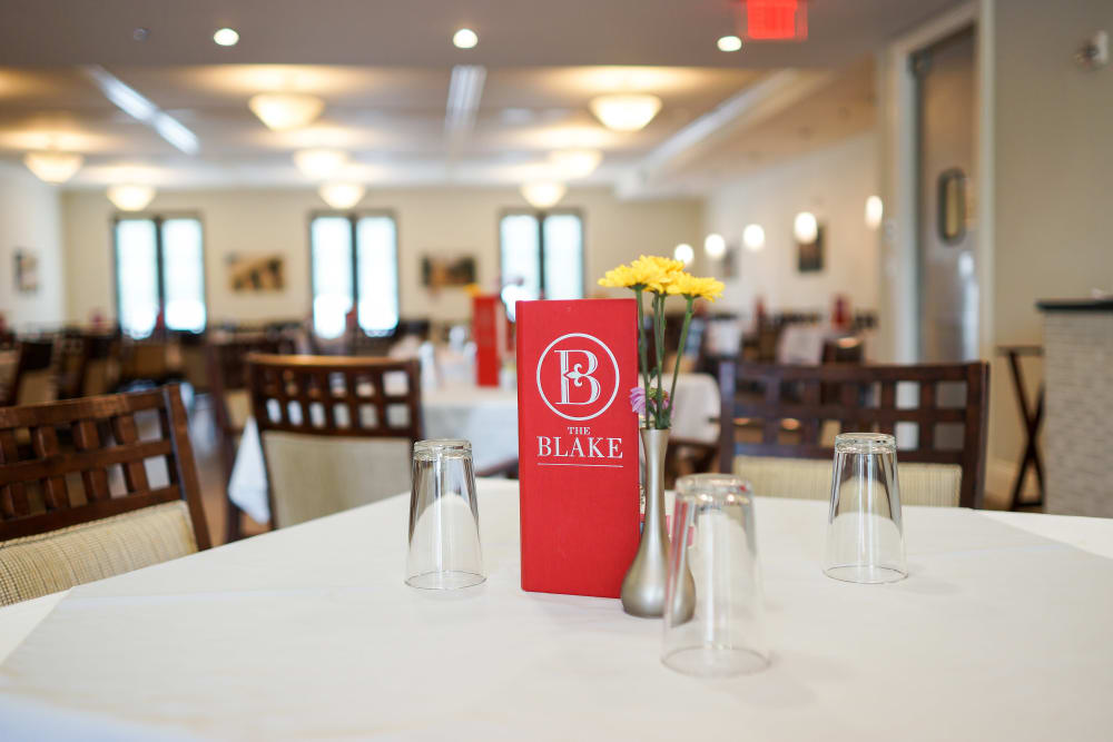 Dining hall table with a menu on it at The Blake at Flowood in Flowood, Mississippi