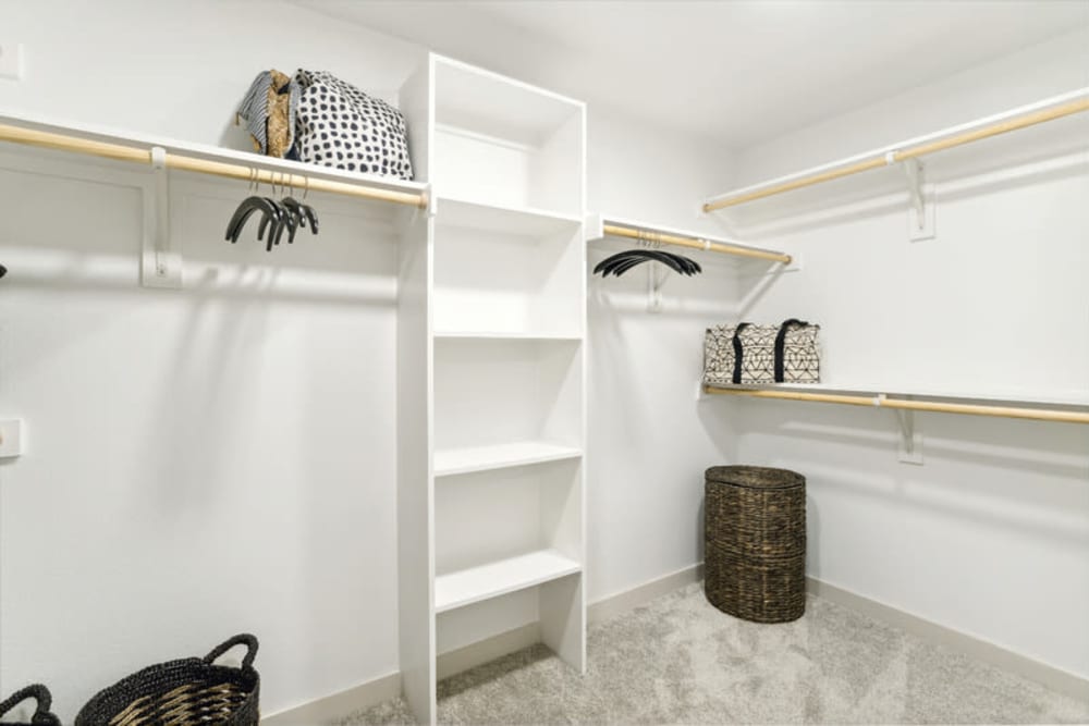 Large walk-in closet with built-in shelving at The Margaret at Riverfront in Dallas, Texas