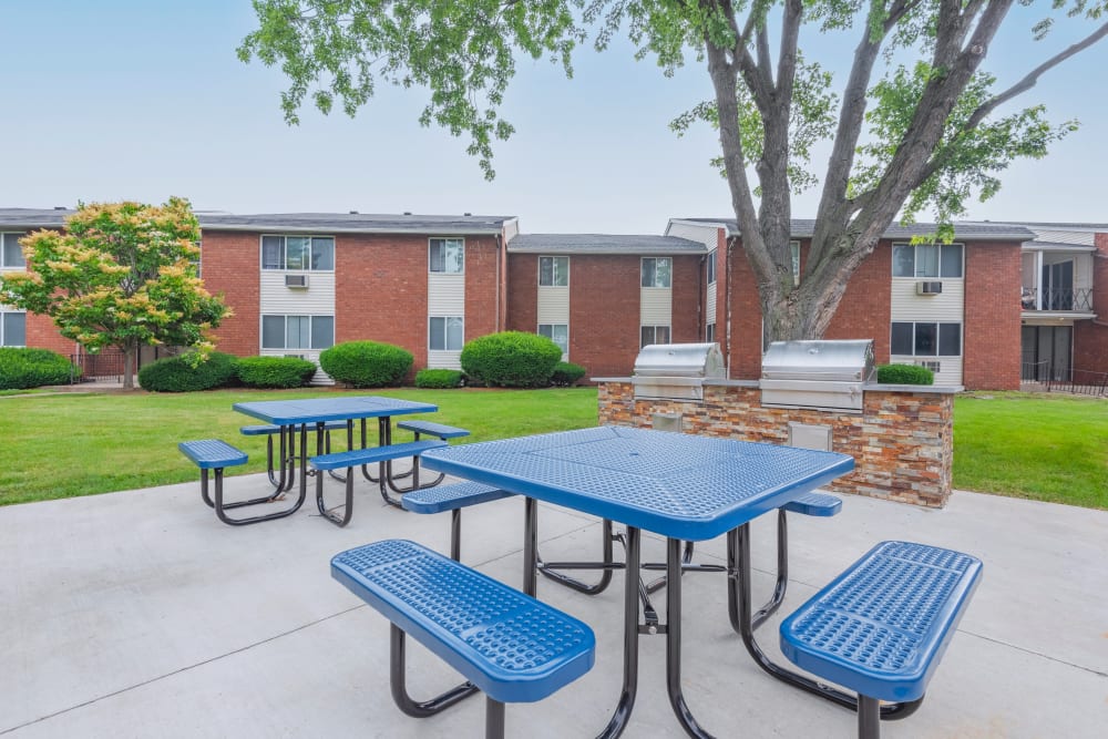 Grilling stations with 2 picnic tables at King's Court Manor Apartments in Rochester, New York