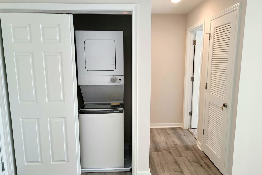 Washer and dryer combo area in apartments with utilities included located at Hickory Creek Apartments & Townhomes in Nashville, Tennessee
