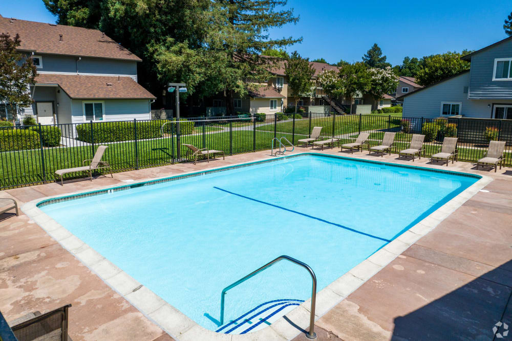 Lounge chairs by the pool at Creekside Park Apartments in Napa, California