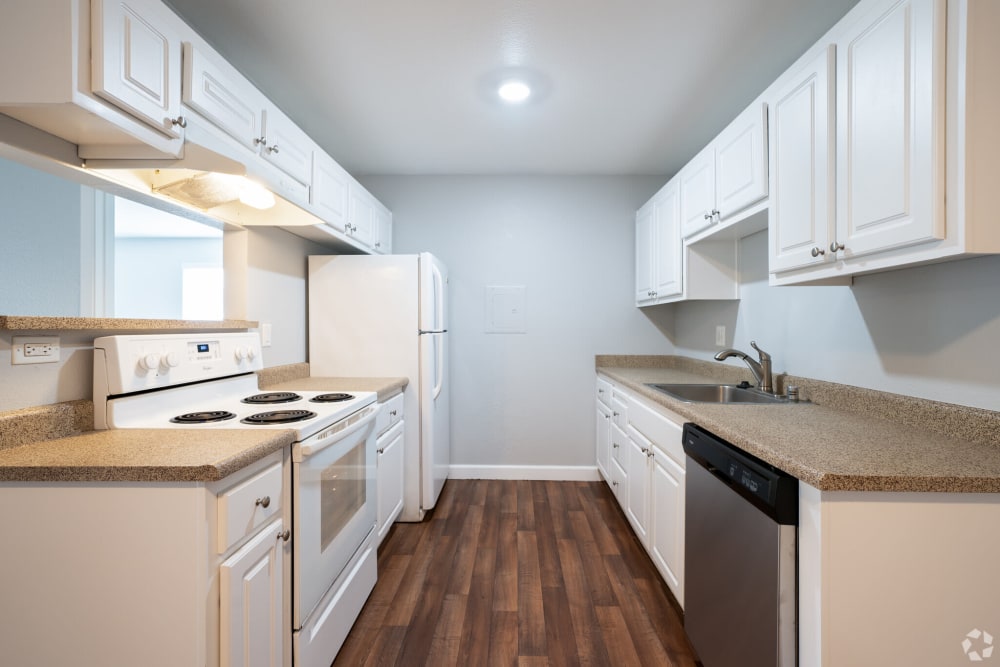Kitchen with white cabinetry at Creekside Park Apartments in Napa, California