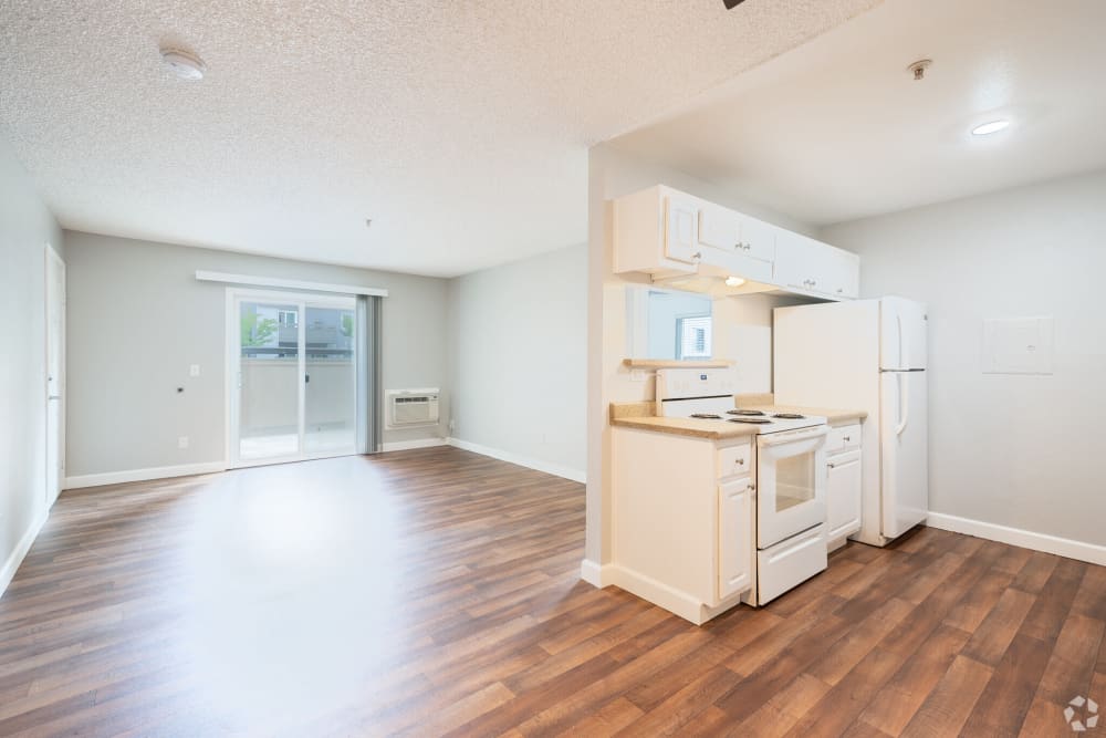 Living room with balcony access at Creekside Park Apartments in Napa, California
