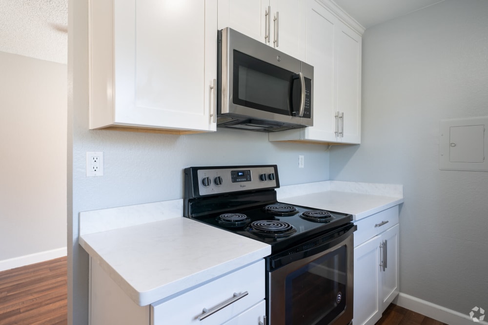 Kitchen with white cabinetry at Creekside Park Apartments in Napa, California