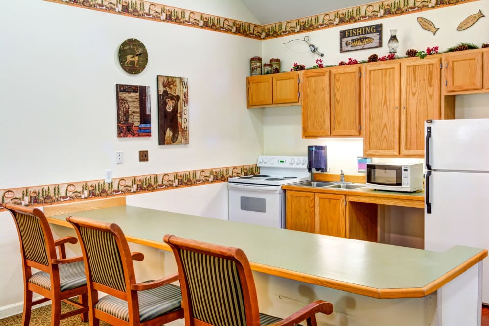 Fully equipped community kitchen with counter seating at Callahan Court Memory Care in Roseburg, Oregon