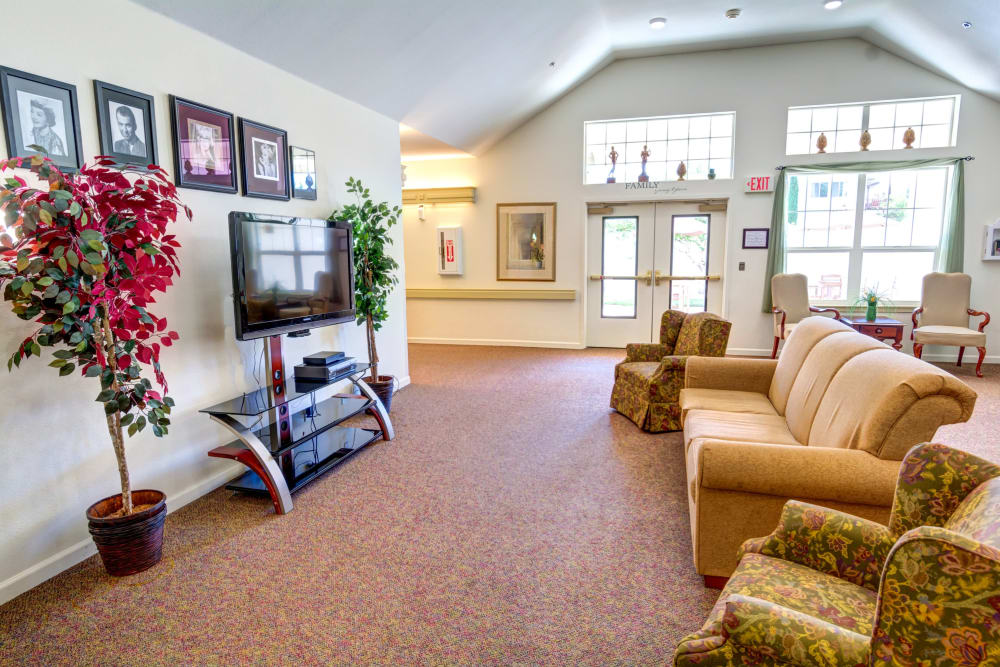 Cozy couch and armchairs in the TV lounge at Callahan Court Memory Care in Roseburg, Oregon