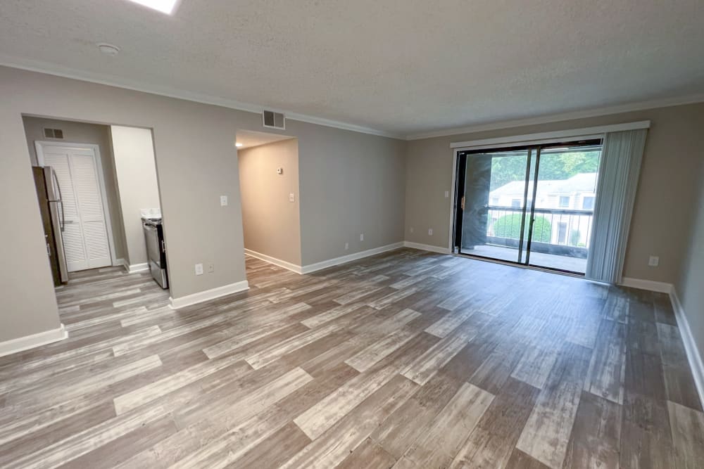 Wood flooring and a sliding door to the balcony in a model apartment at Pinewood Station in Hillsborough, North Carolina