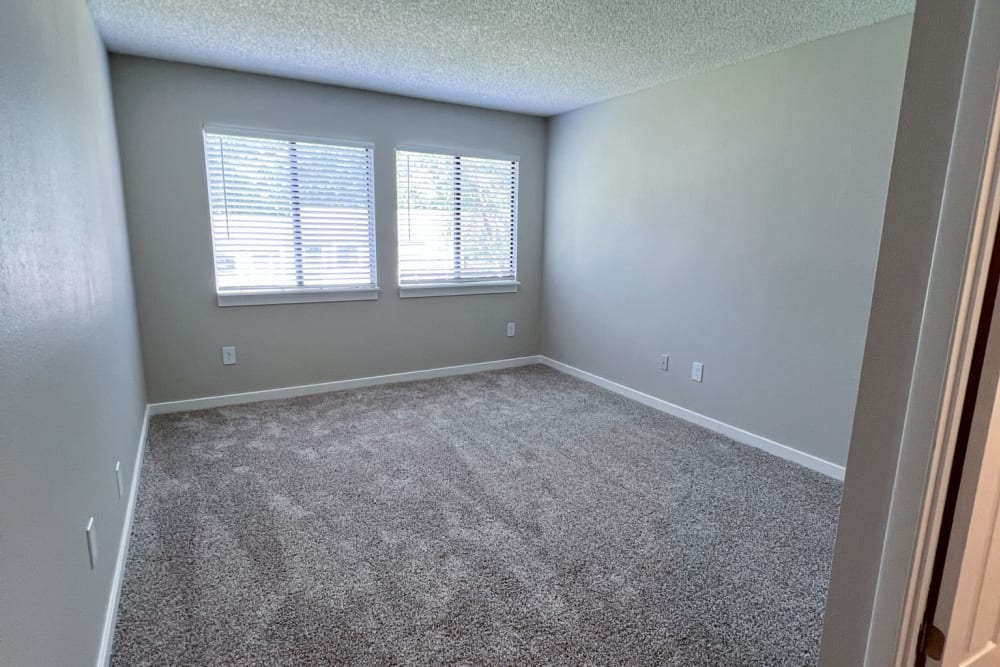 Plush carpeting and a double window in a model apartment bedroom at Pinewood Station in Hillsborough, North Carolina
