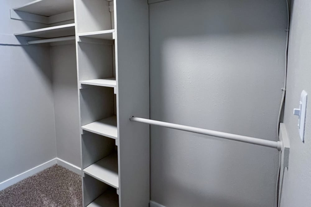 Built-in cabinets and a shelf in an apartment closet at Pinewood Station in Hillsborough, North Carolina
