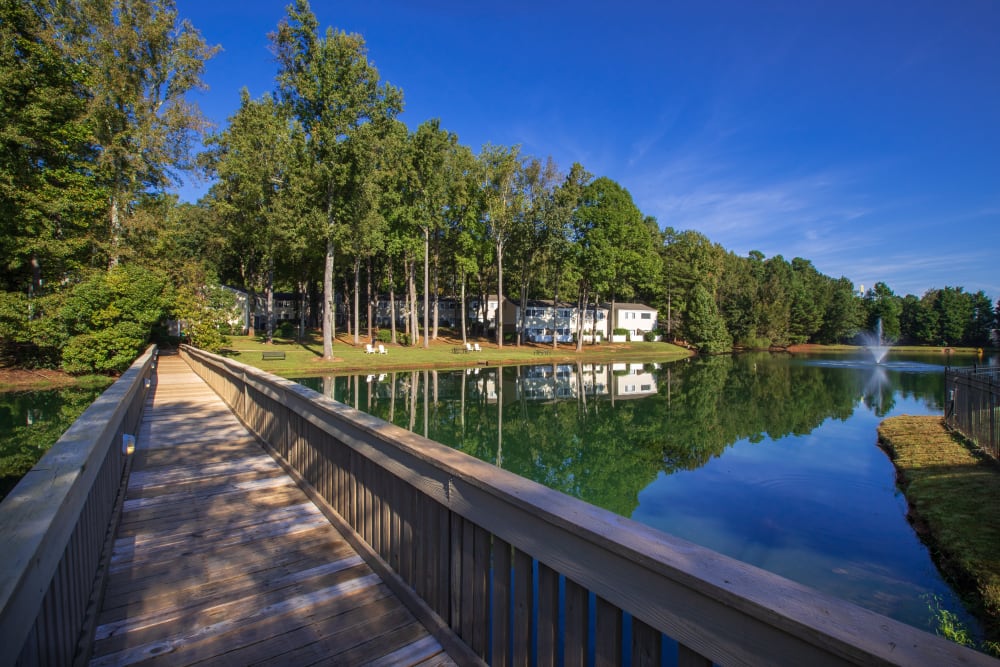 A wood bridge across a scenic pond at Pinewood Station in Hillsborough, North Carolina