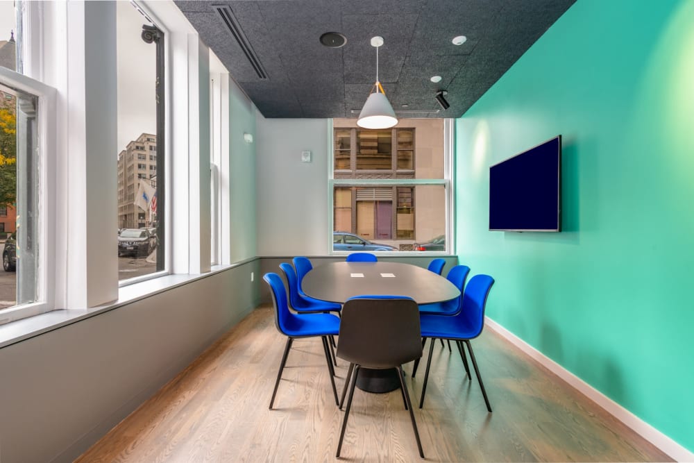 Community meeting space with table and chairs at One India Street Apartments in Boston, Massachusetts