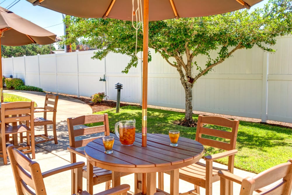 Outdoor patio tables with umbrellas at Callahan Court Memory Care in Roseburg, Oregon