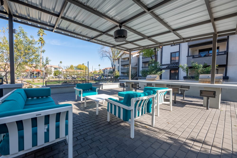 Covered outdoor lounge with BBQs at Asteria Apartments in Tempe, AZ
