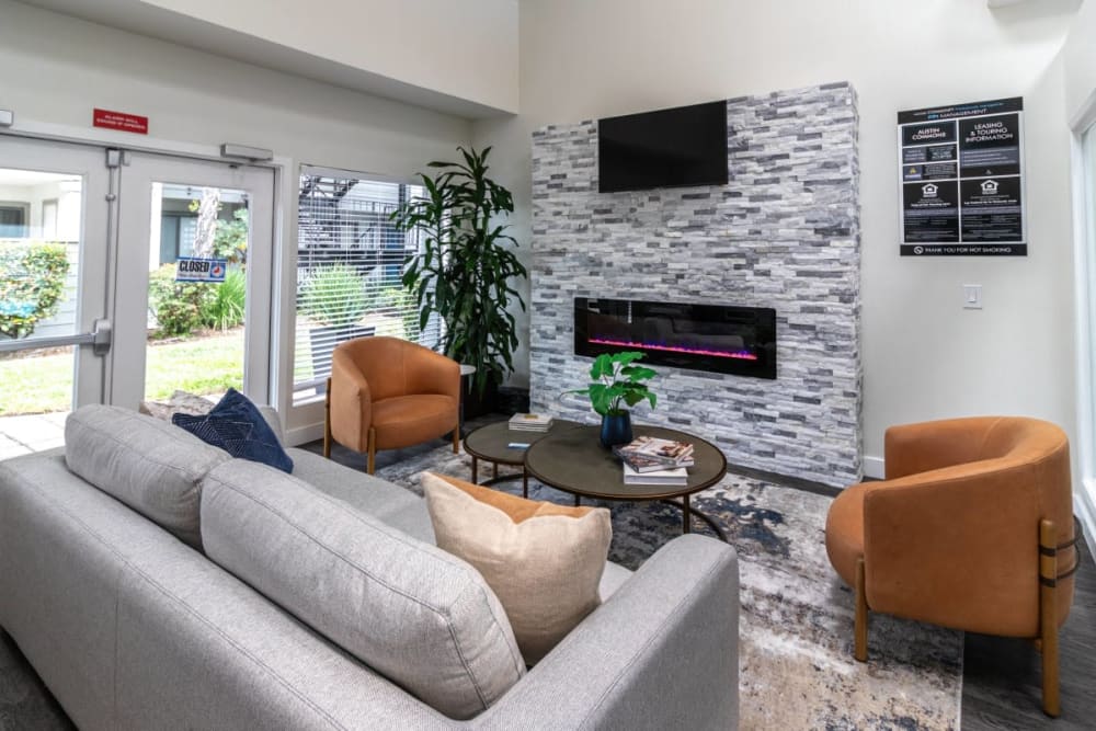 Clubhouse lounge with fire place at Austin Commons Apartments in Hayward, California