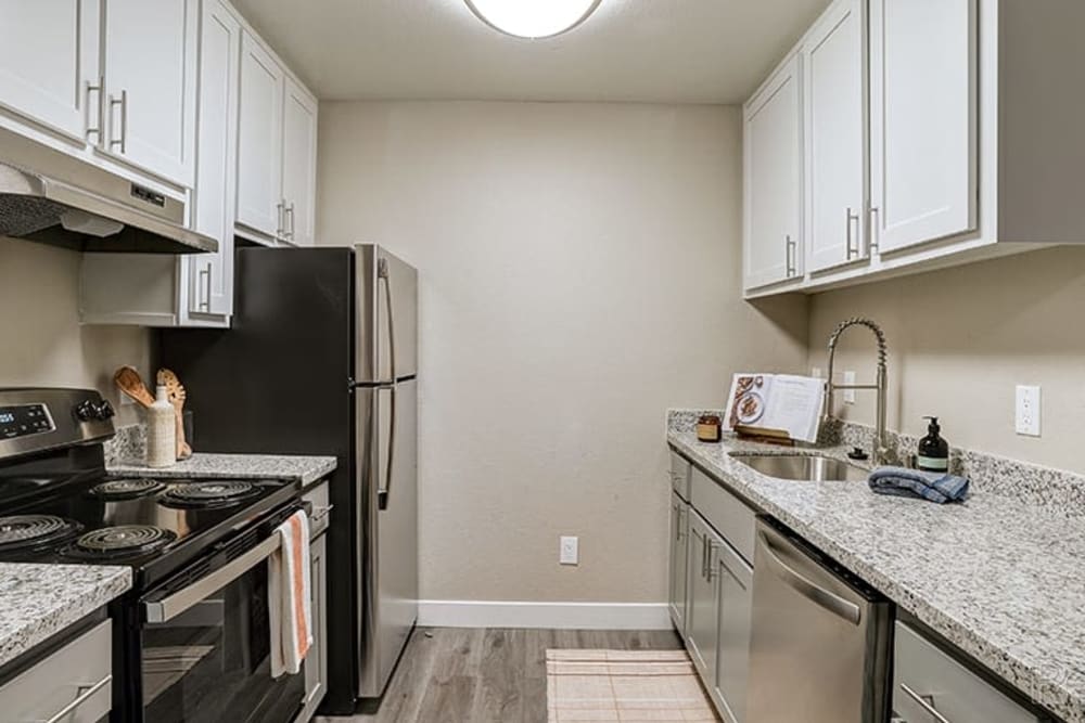 Kitchen with marble countertops at Austin Commons Apartments in Hayward, California