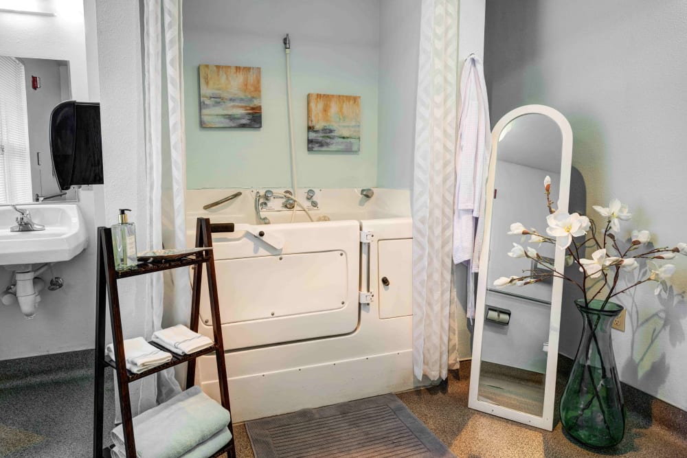 Large bathroom with a walk-in tub in an assisted living apartment at Callahan Village Retirement  and Assisted Living in Roseburg, Oregon