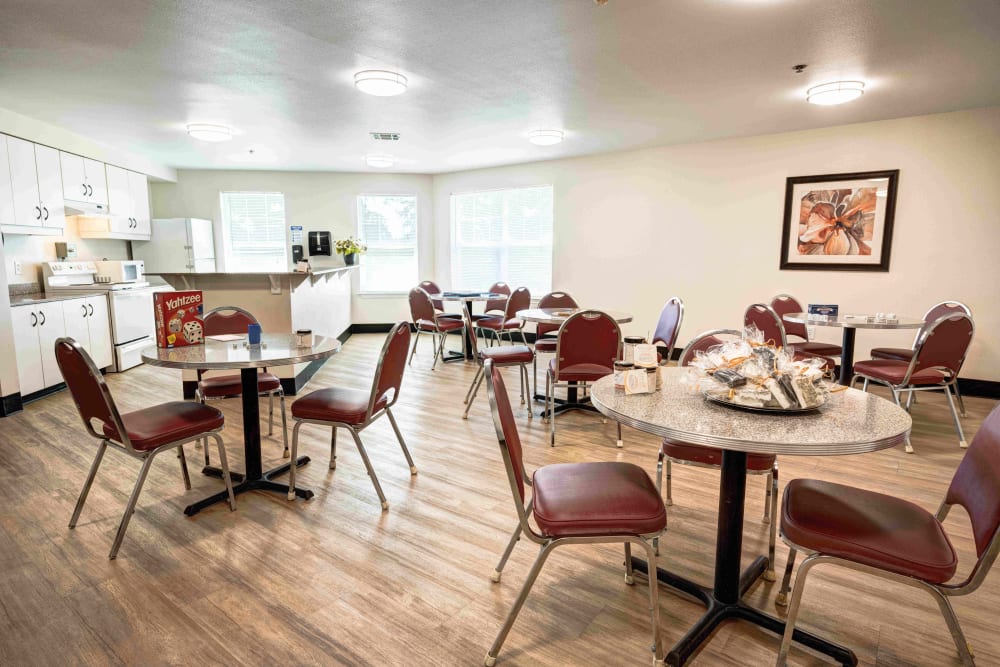 Community room with a fully equipped kitchen and tables for games or dining at Callahan Village Retirement  and Assisted Living in Roseburg, Oregon
