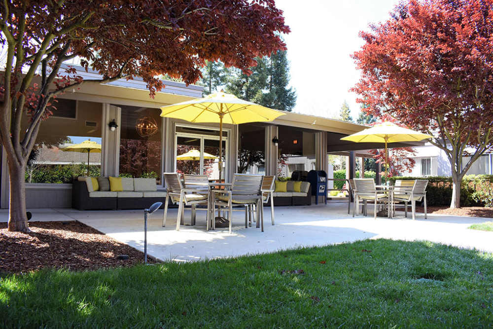 Patio tables with umbrellas and outdoor lounge seating at Parc Station in Santa Rosa, California