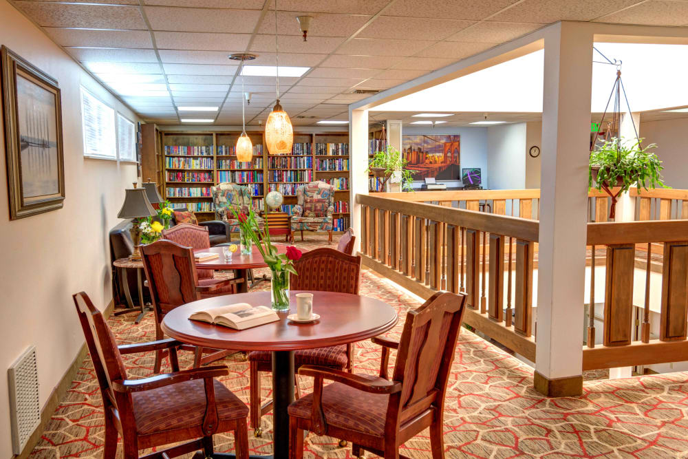Library and tables for reading or gathering with friends at Junction City Retirement and Assisted Living in Junction City, Oregon