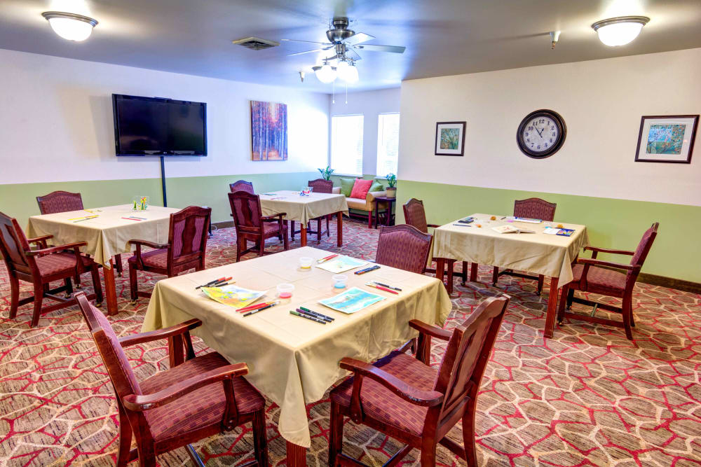 Game and activity tables with painting supplies at Junction City Retirement and Assisted Living in Junction City, Oregon