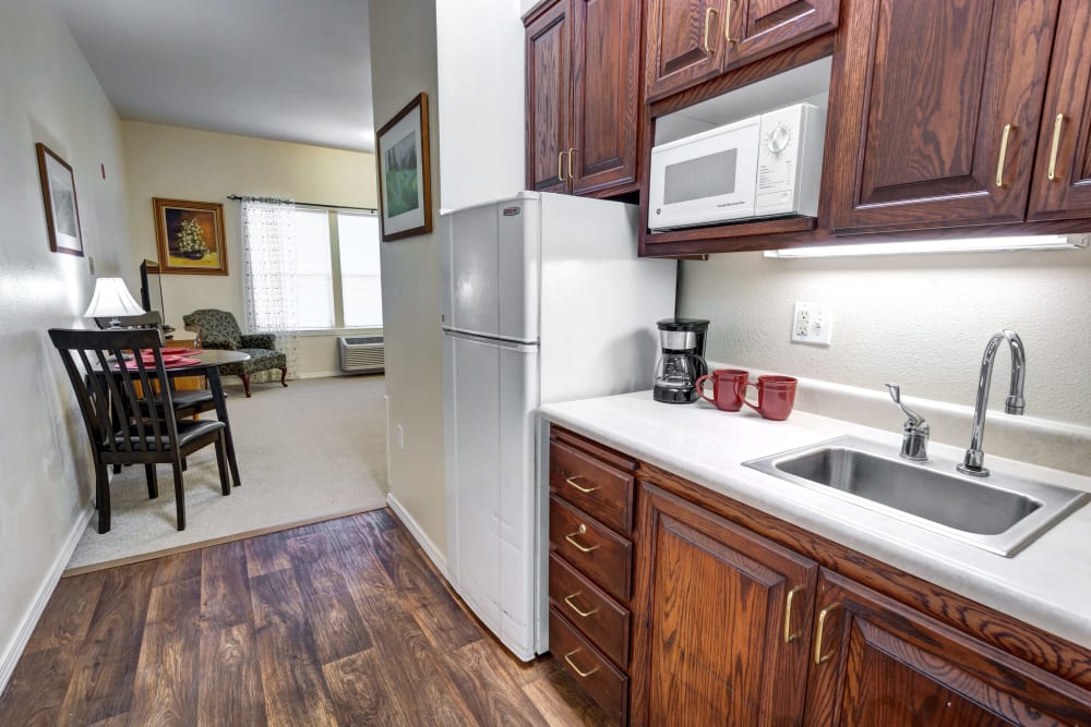 Fully equipped kitchen with wood-style plank flooring at Hawks Ridge Assisted Living in Hood River, Oregon