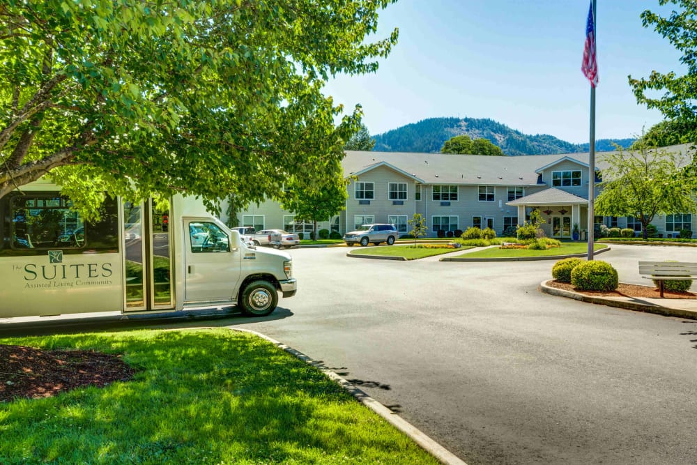 Street view of the shuttle bus and exterior at The Suites Assisted Living and Memory Care in Grants Pass, Oregon