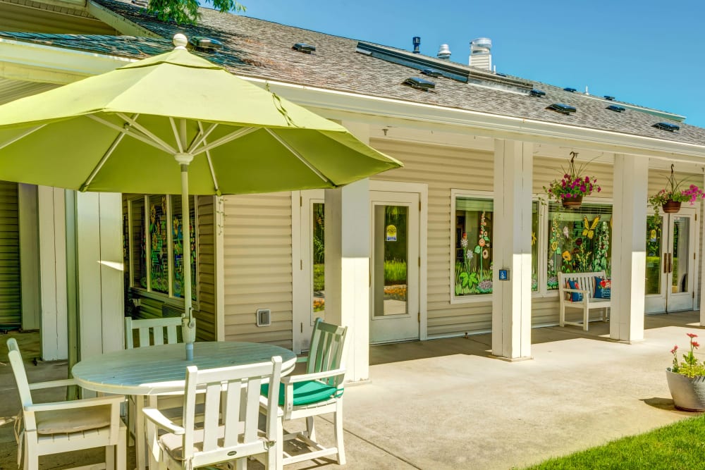 Patio table with an umbrella outside The Suites Assisted Living and Memory Care in Grants Pass, Oregon