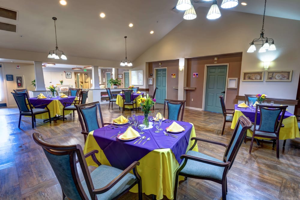 Dining room with cathedral ceilings and pendant lighting at Timberwood Court Memory Care in Albany, Oregon