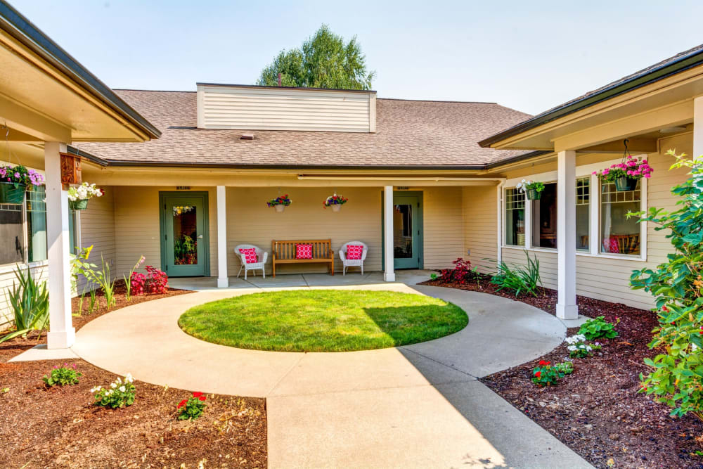Courtyard with shaded veranda seating at Timberwood Court Memory Care in Albany, Oregon