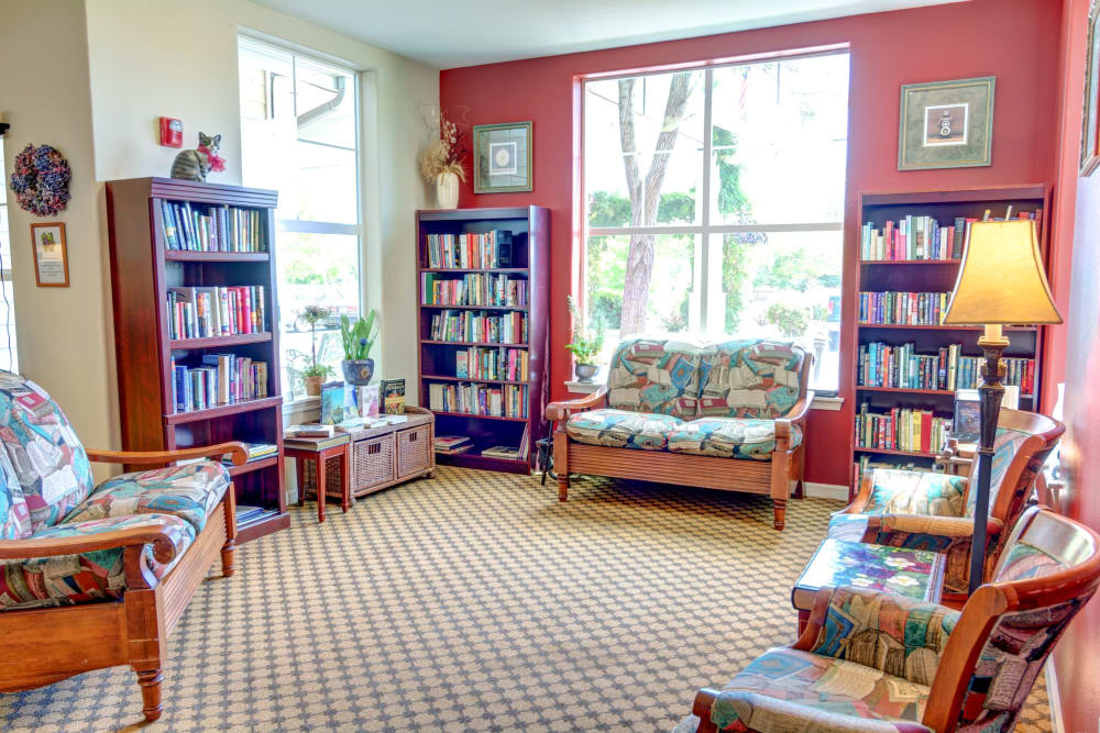 Cozy library with plenty of seating for reading at Vineyard Heights Assisted Living in McMinnville, Oregon