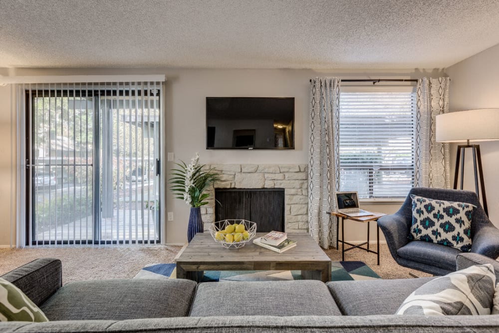 Apartment living space with a fireplace at The Commons in Federal Way, Washington