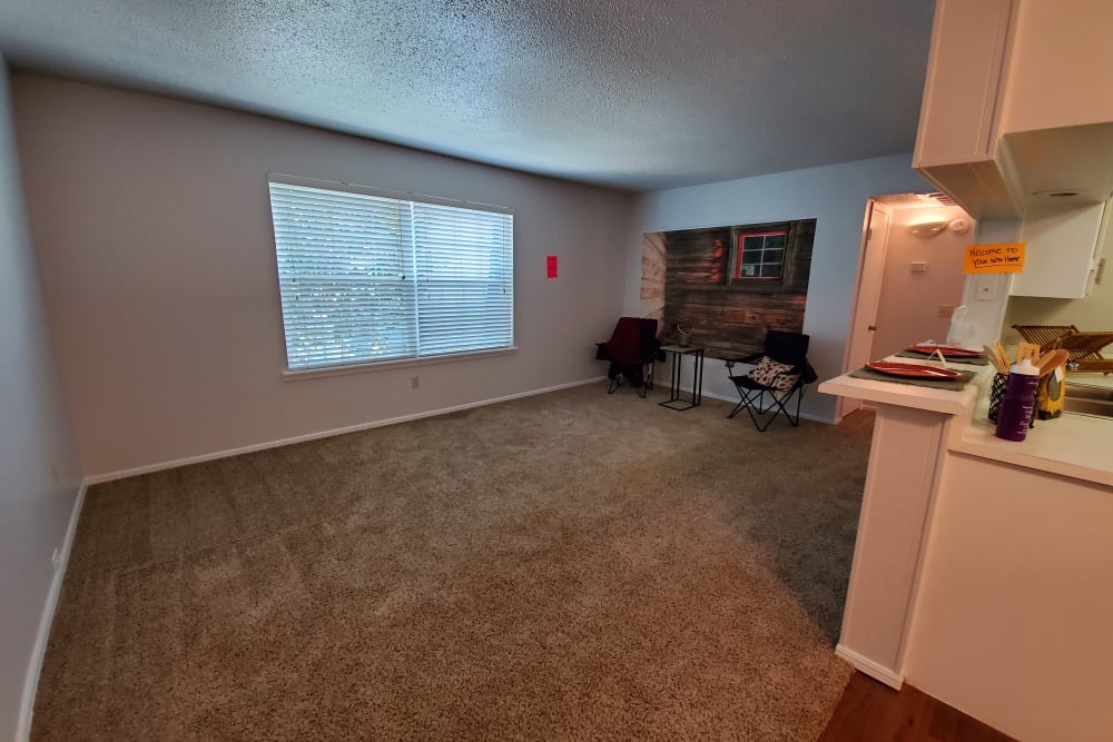 Model apartment living room with carpet at Pickwick Place in Oklahoma City, Oklahoma