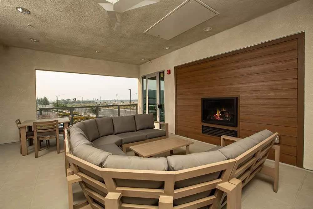 Trendy, spacious clubhouse lounge with fireplace at Allure Apartments in Modesto, California