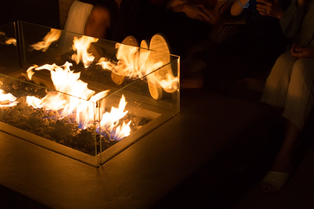 Residents relaxing around the rooftop fire pit at Mosaic in Los Angeles, California