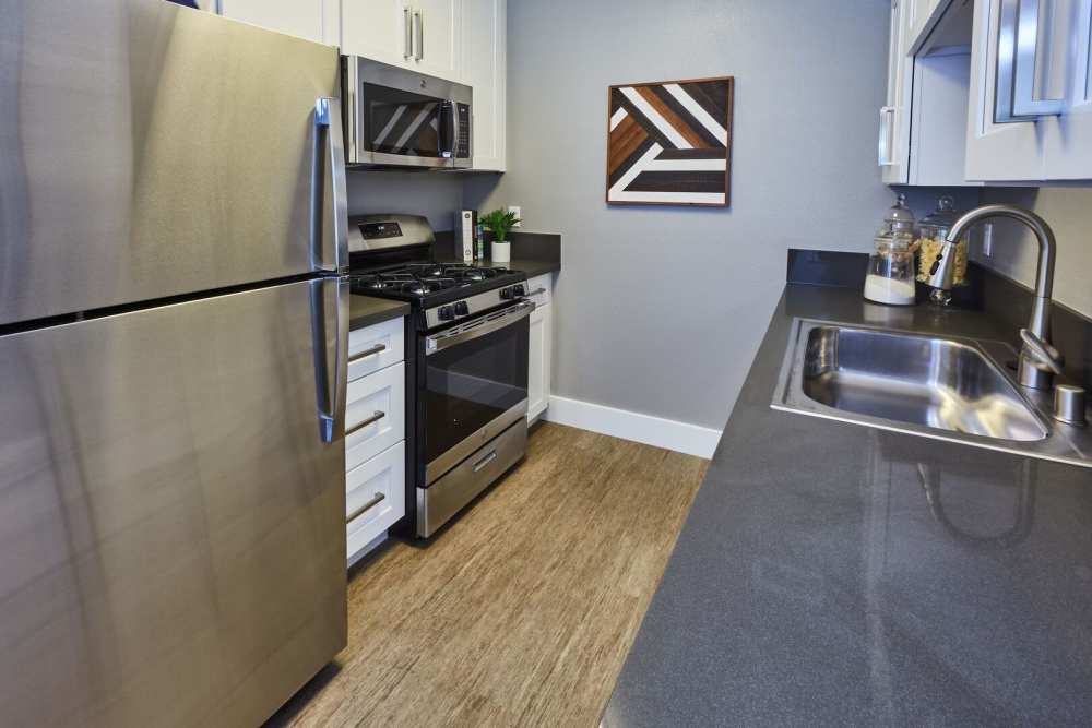 White cabinet kitchen with stainless steel appliances at Surfside Villas in Huntington Beach, California