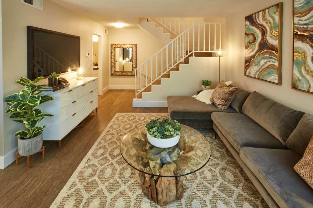Spacious living room with television and wood flooring at Surfside Villas in Huntington Beach, California