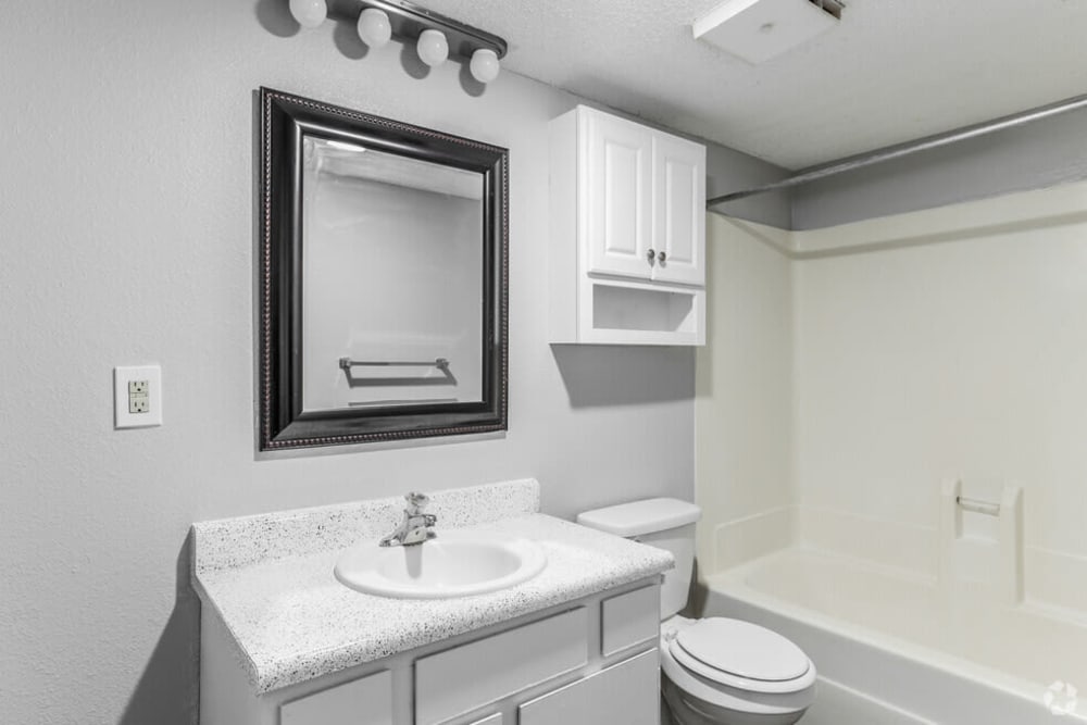 bathroom vanity, shower tub and vanity mirror at Midwest City Depot in Midwest City, Oklahoma