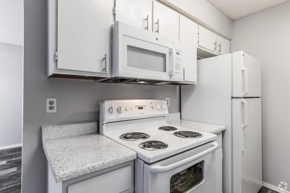 Kitchen with white cabinetry and appliances at at Midwest City Depot in Midwest City, Oklahoma