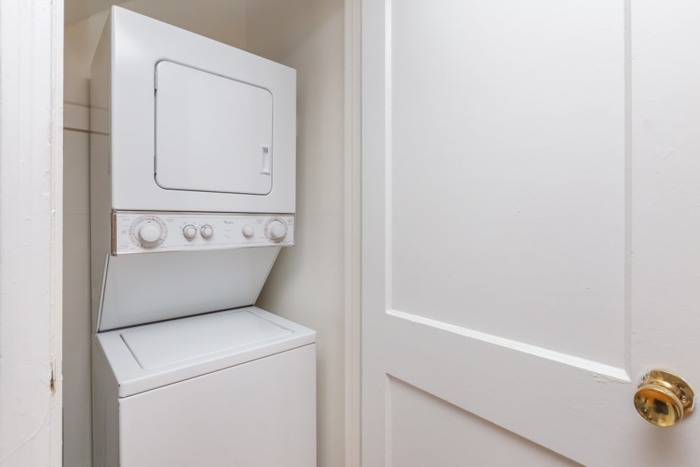 A stacked washer and dryer in an apartment at Cottage Grove Apartments in Newport News, Virginia