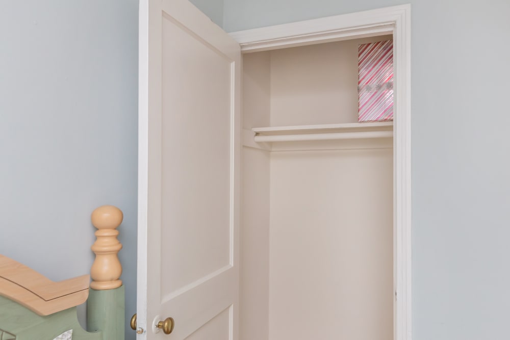 An open closet door in an apartment bedroom at Cottage Grove Apartments in Newport News, Virginia
