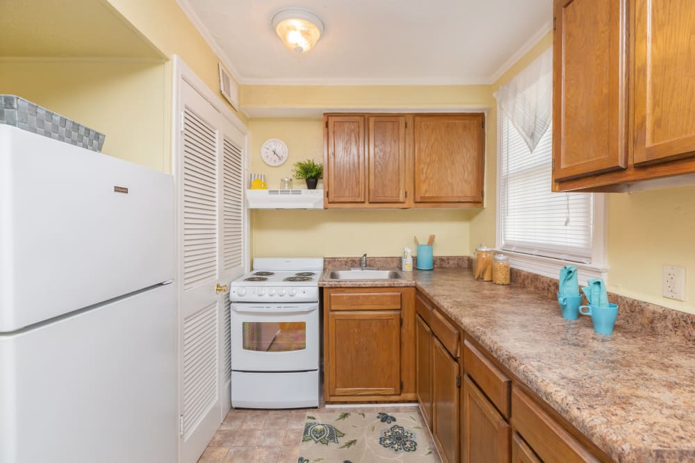 White appliances in an apartment kitchen at Cottage Grove Apartments in Newport News, Virginia